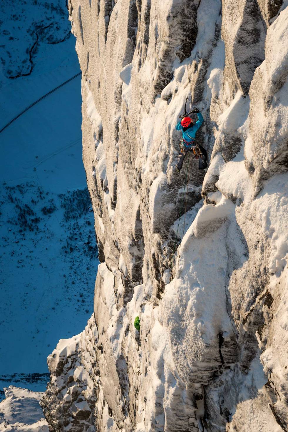 Stille før solen: Ines Papert og Nina Schlesener klatrer en sørvent vegg, men måtte snu da solen traff veggen og det begynte å rase is. – En skremmende opplevelse, sa Ines. Foto: Thomas Senf Havets-vinterparadis-senja-3