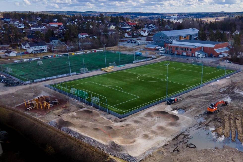 PERFEKT BELIGGENHET: Pumptracken på Manstad ligger i tilknytning til eksisterende idrettsanlegg like ved både barne- og ungdomsskolen og med et helt stinettverk like i nærheten. Nå er banen også ferdig asfaltert. Foto: Trailhead Nesbyen Pumptracken på Manstad